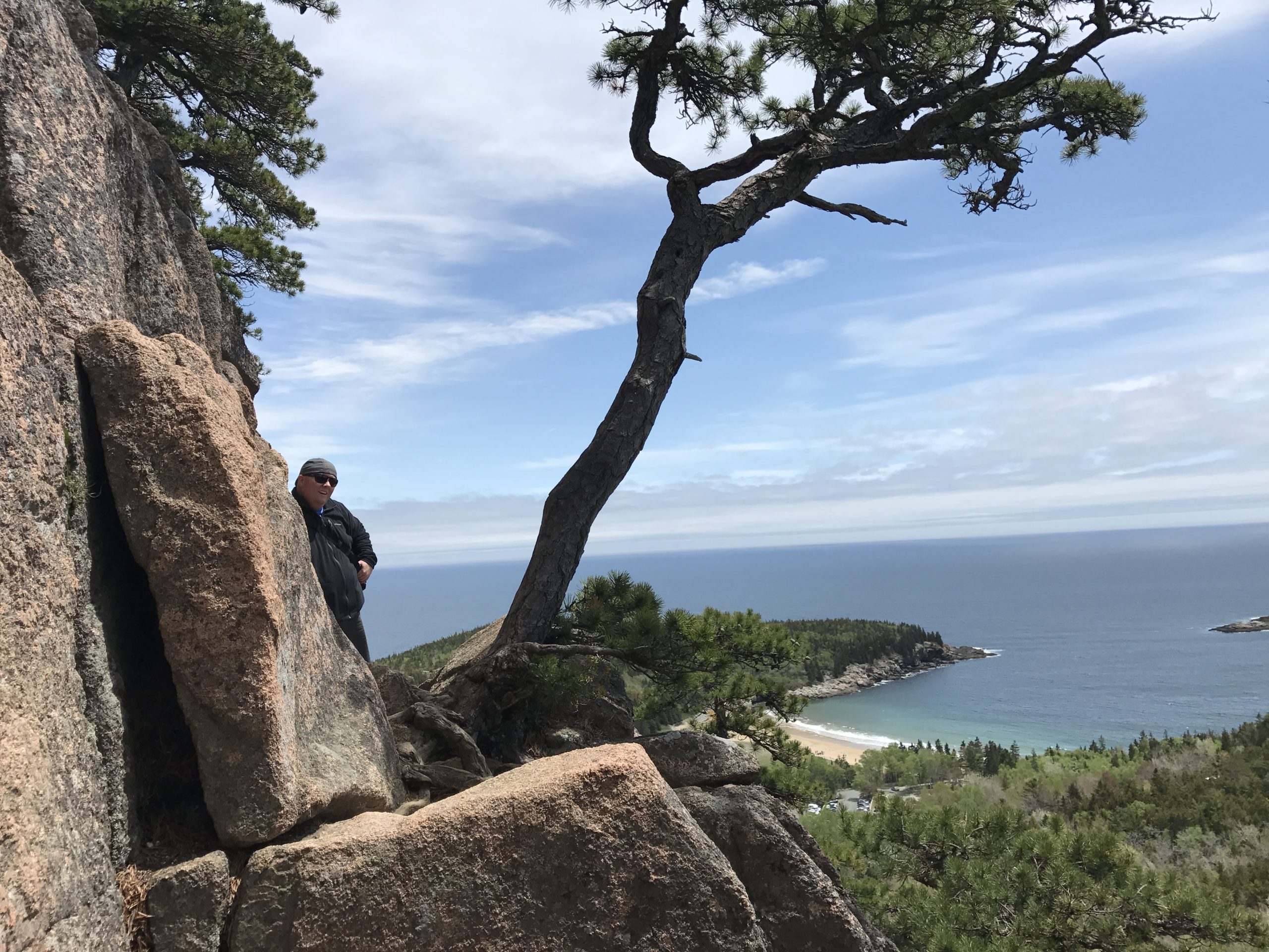Man Looking Over Cliff Edge On Beehive Trail Acadia National Park