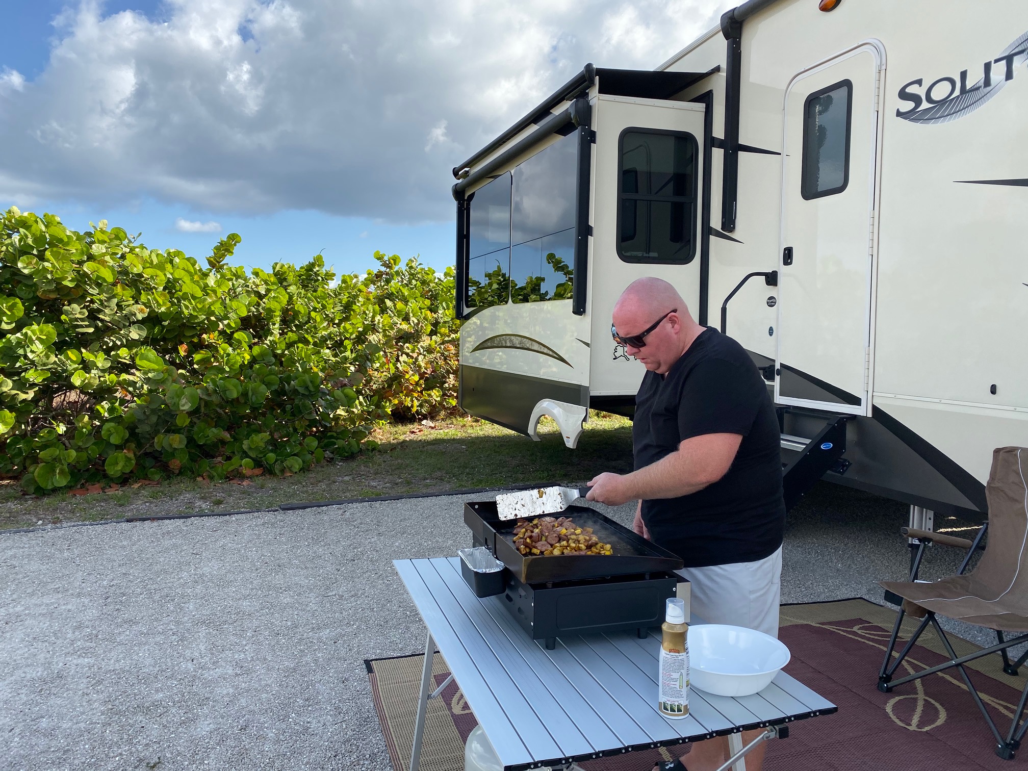 Man camping cooking outside rv travel guide find your camping style