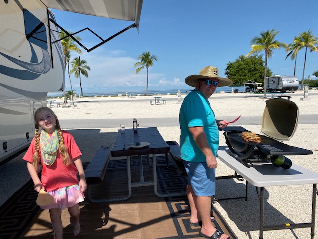 Man And Girl Grilling At Ocean View RV Site RV Travel Guide