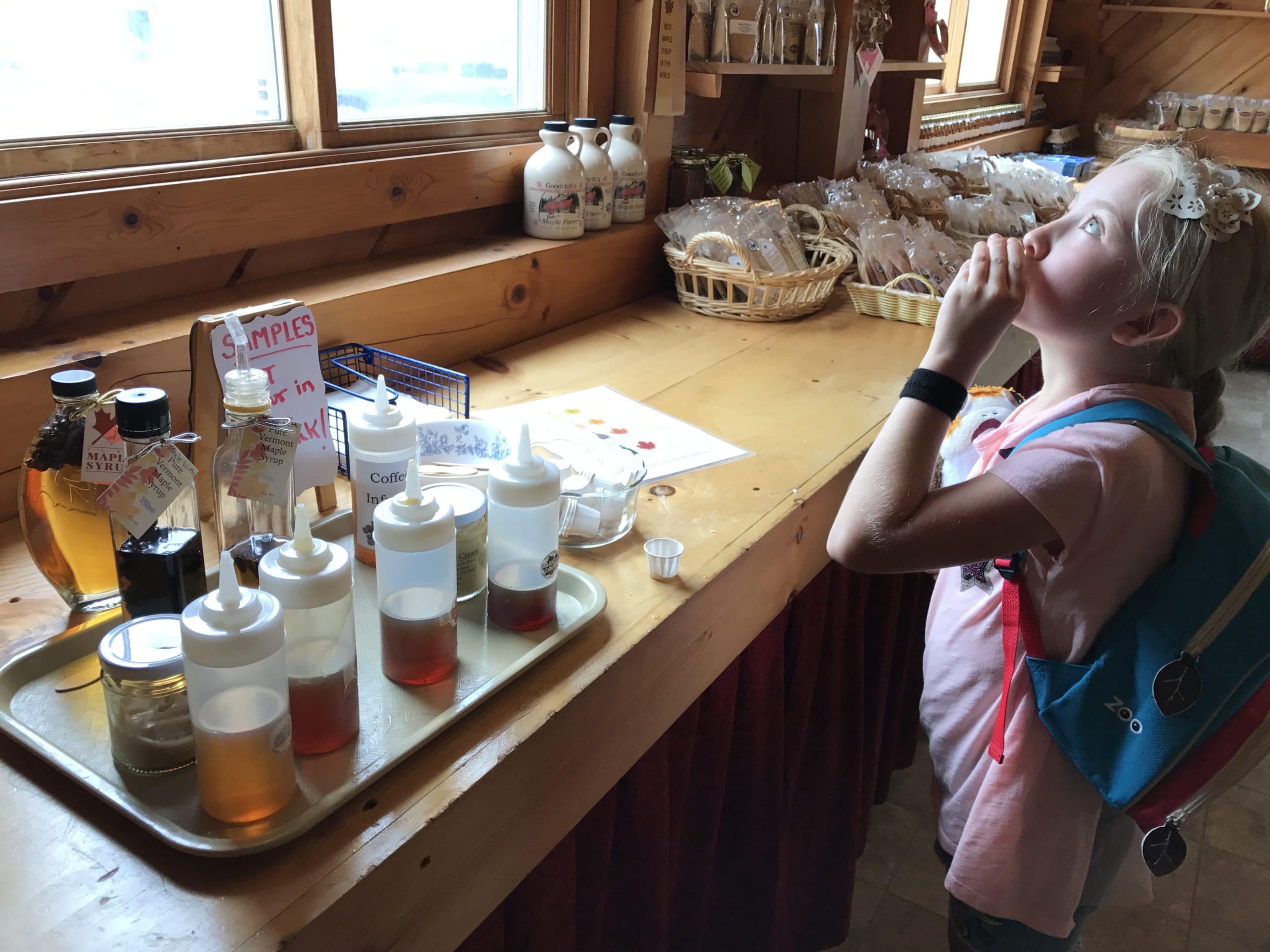 A Girl Is Sampling Syrup At Goodrich Maple Farm Things To Do Near Stowe Vermont