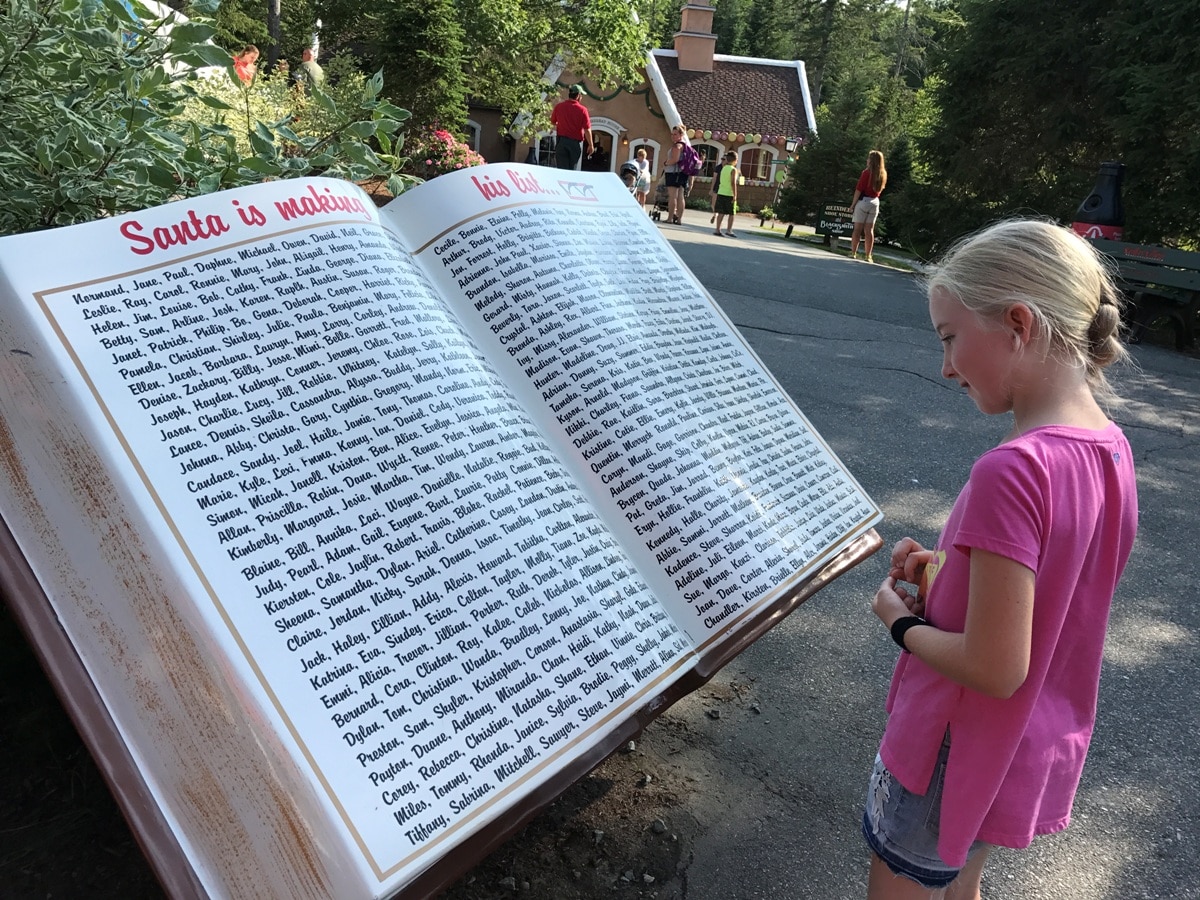 Girl Reads Santa's Nice List At Santa's Village Jefferson New Hampshire Christmas Theme Parks