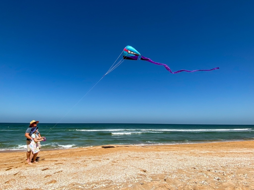Man and Girl Flying Kite On The Beach Tips Living In An RV Full Time