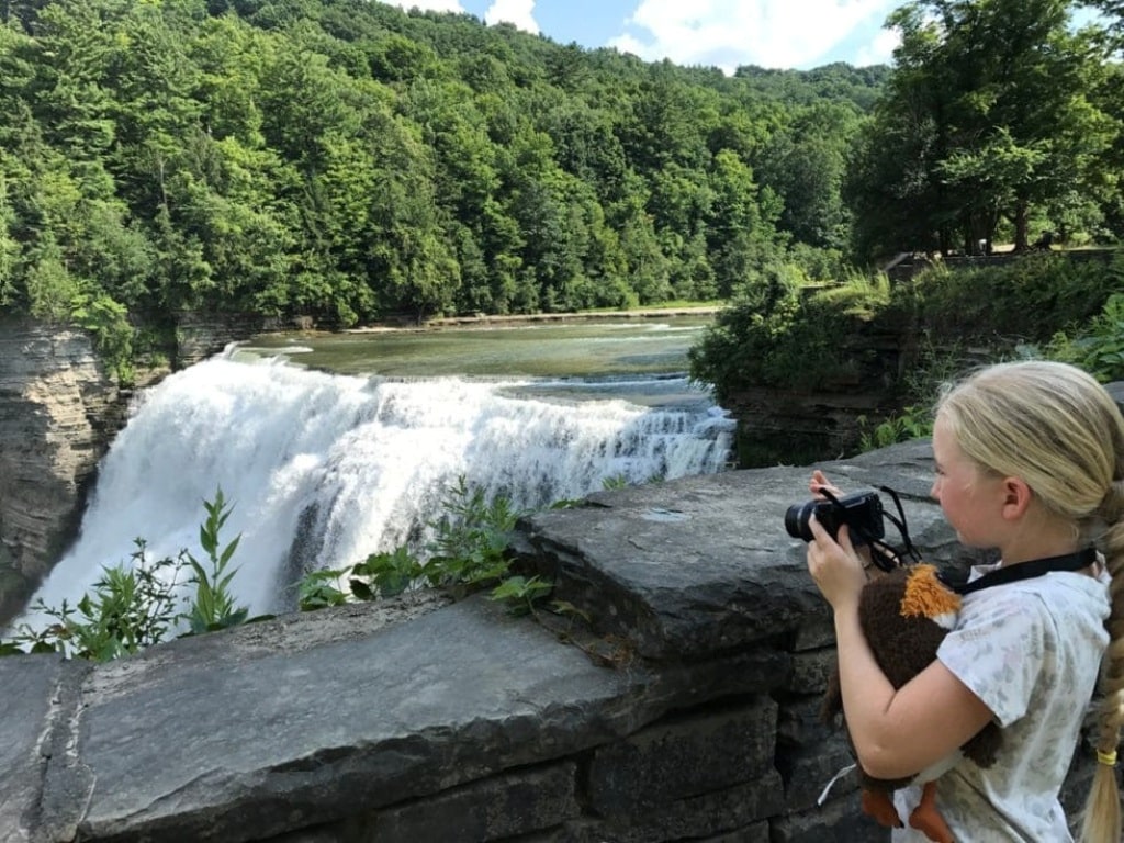 Girl Taking Photo Of Waterfall Tips Living In An RV Full Time