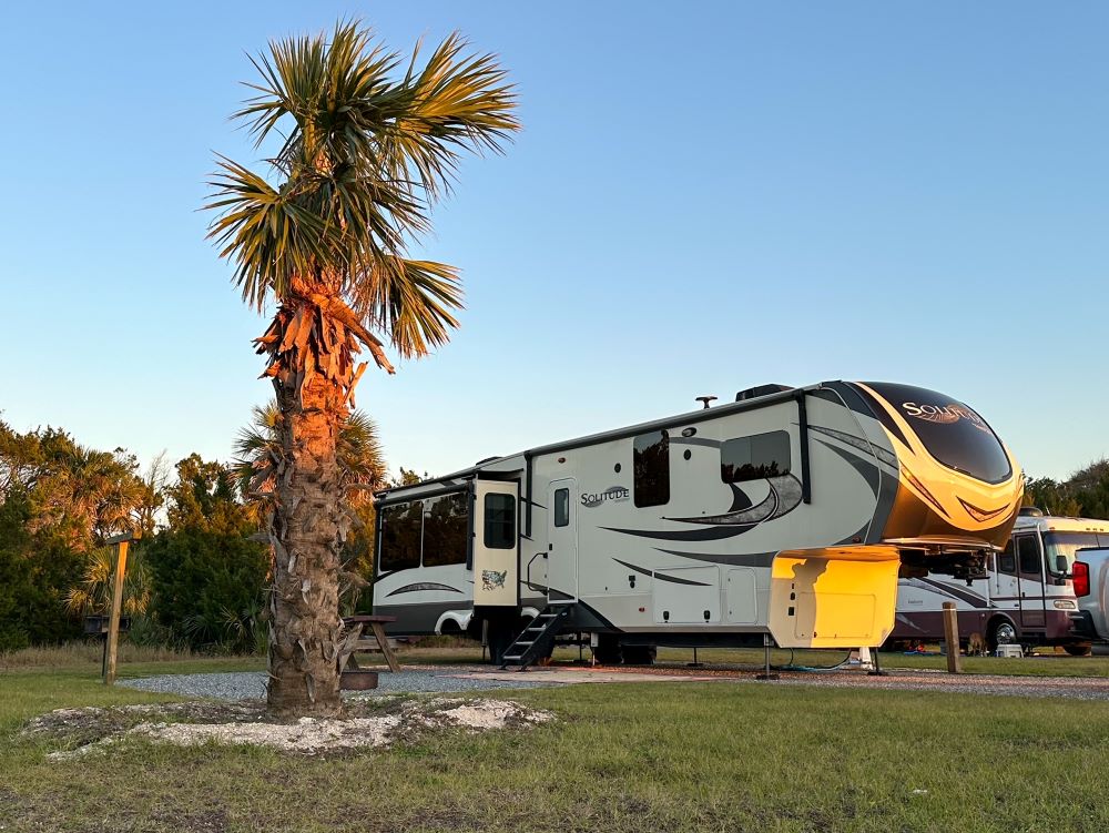 RV in state park campground with palm tree