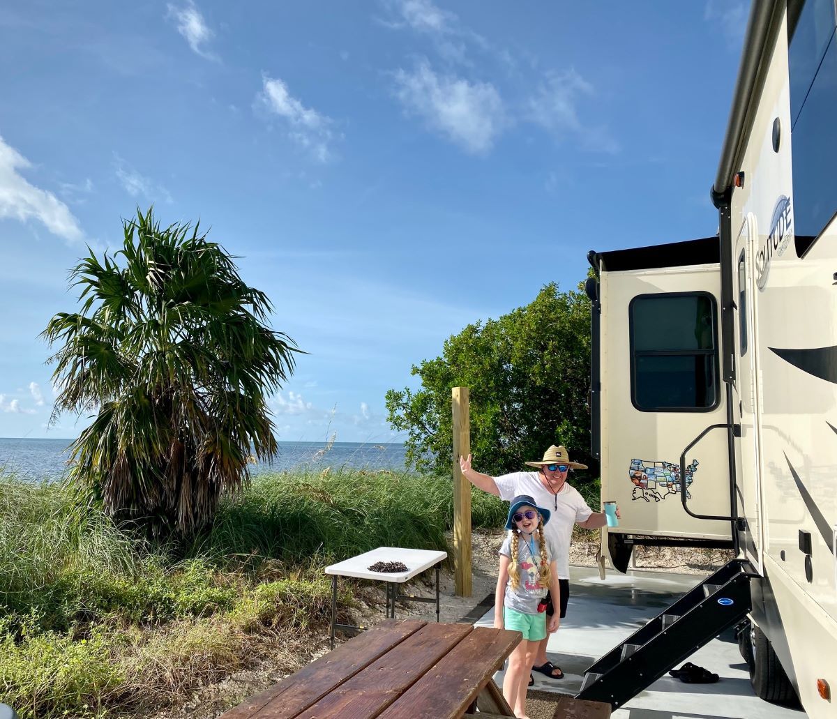 Man and Daughter Camping On The Ocean In Florida - Florida Camping Guide