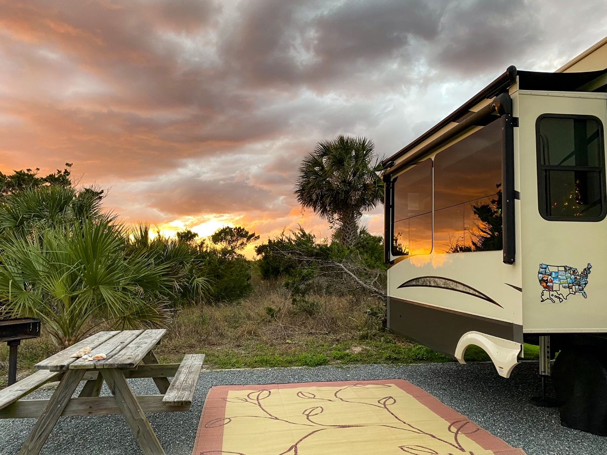 RV with sunset reflection - What does it cost to live in an RV?