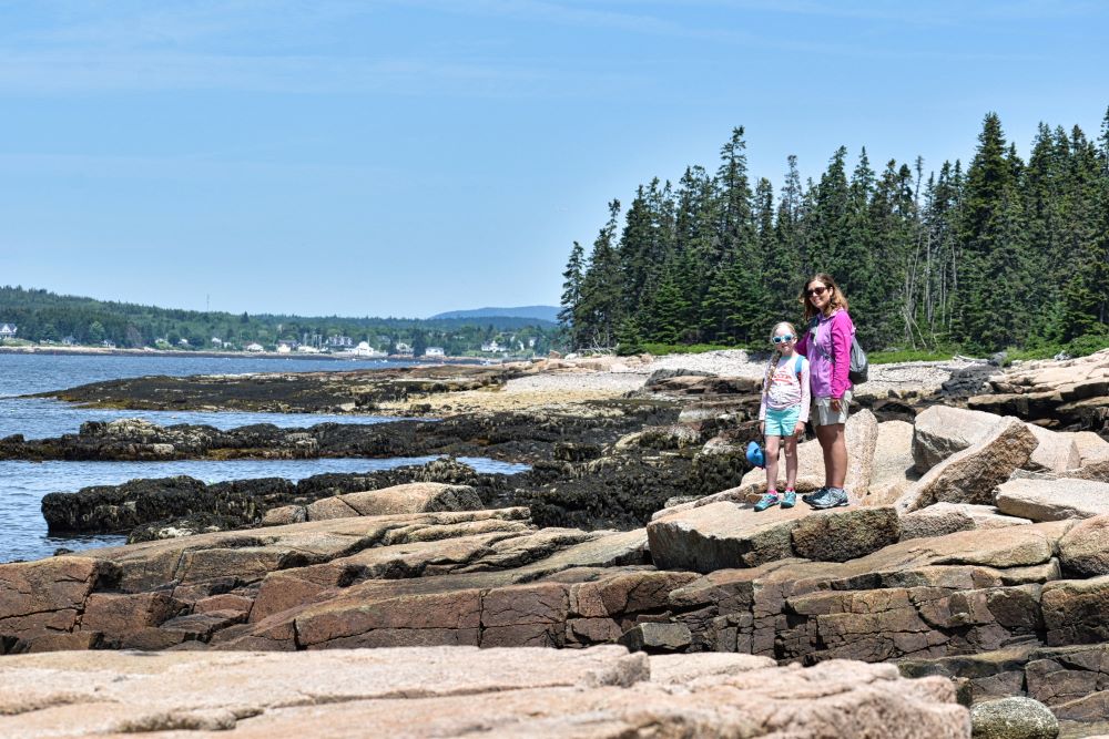 Mom and daughter standing on the coast in Acadia National Park - Cost of RV living