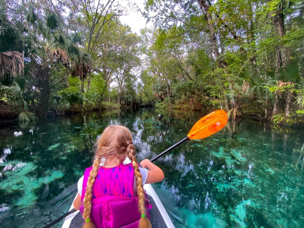Girl paddle boarding in Florida springs - RV travel