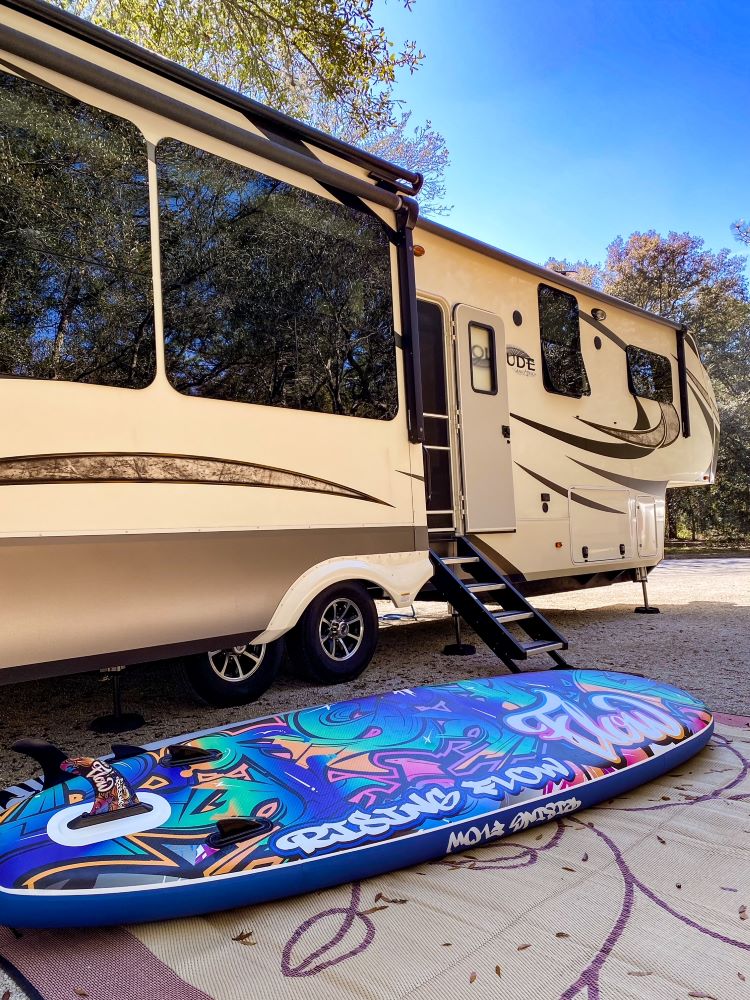 RV in state park campsite with paddleboard - full-time RV living