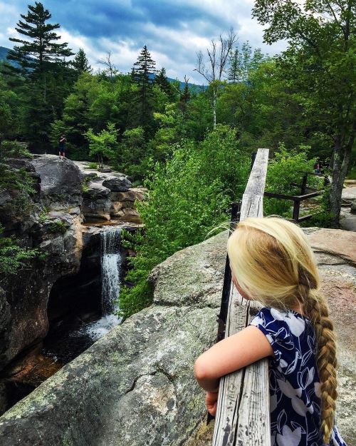 Girl on RV trip at waterfall in Grafton Notch State Park Maine
