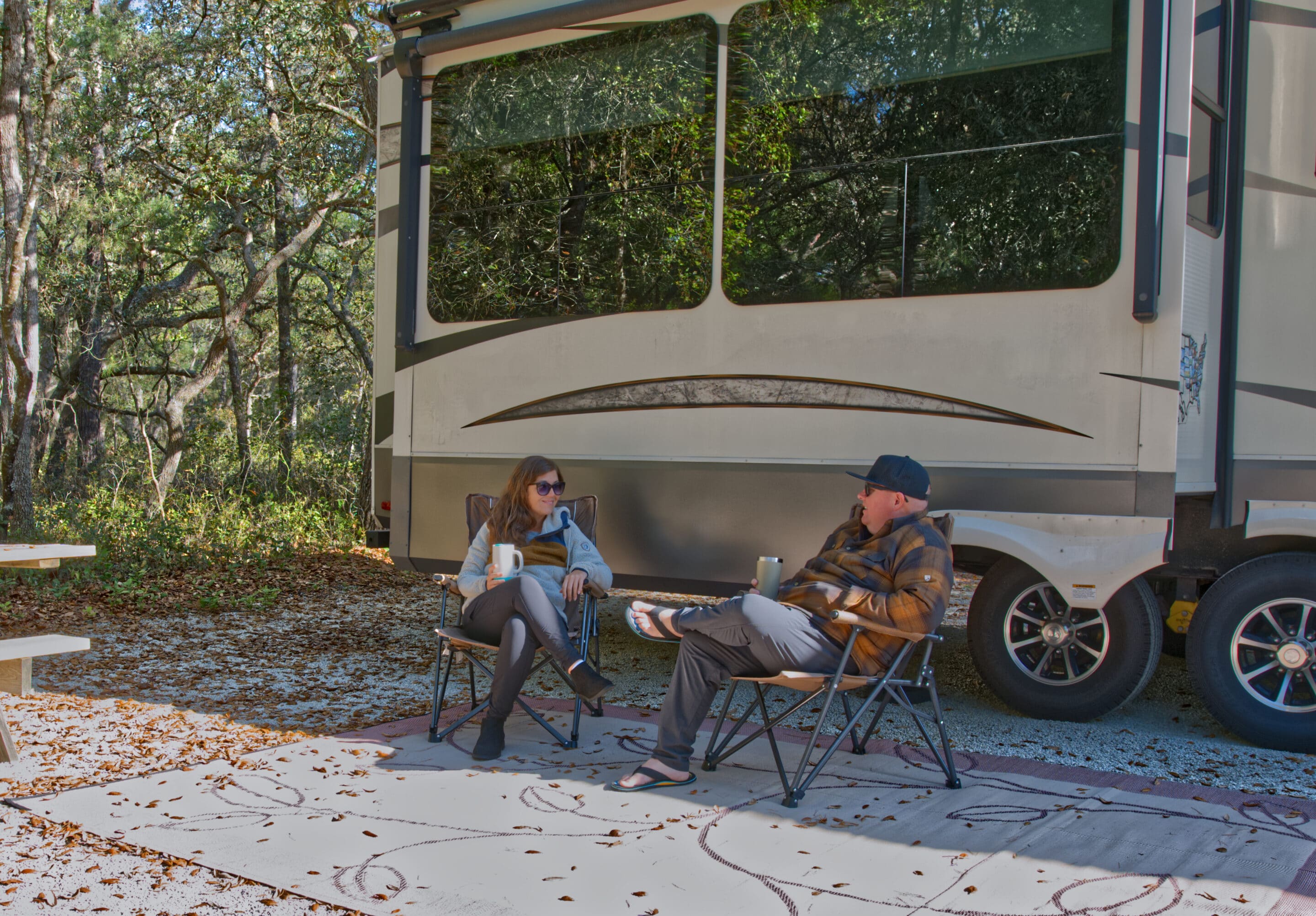 Couple having coffee while RV camping - AI road trip planner