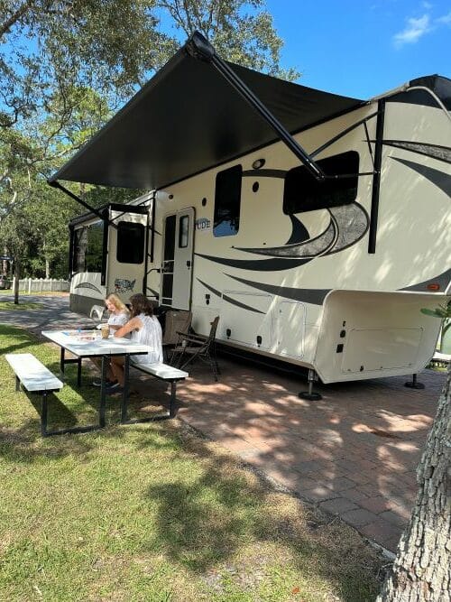 Mom and daughter playing games while RV camping - RV Safety