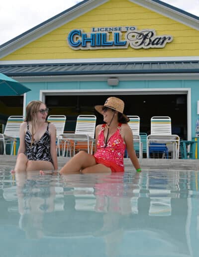 Woman and girl by pool at Camp Margaritaville