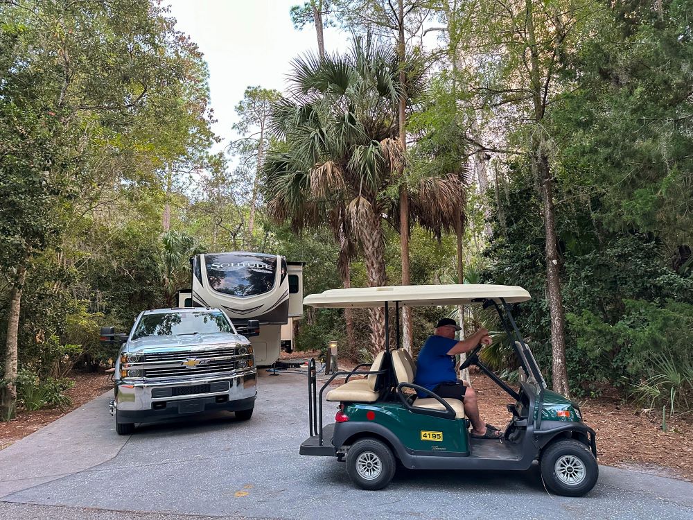 Man in golf cart in RV campsite